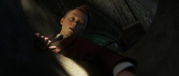 Movie still from “The Adventures of Tintin” (2011), directed by Steven Spielberg – A young man in a suit and tie looking at the camera; Close Up shot, High angle
