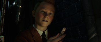 Movie still from “The Adventures of Tintin” (2011), directed by Steven Spielberg – A young man holding a cell phone in his hand; Close Up shot, High angle