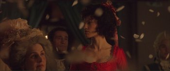Movie still from “The Affair of the Necklace” (2001), directed by Charles Shyer – A man and a woman dressed up in a red dress; Medium shot, Over the shoulder angle