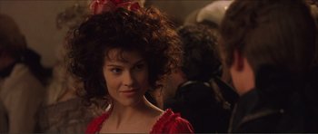 Movie still from “The Affair of the Necklace” (2001), directed by Charles Shyer – A person wearing a red dress; Close Up shot, Over the shoulder angle