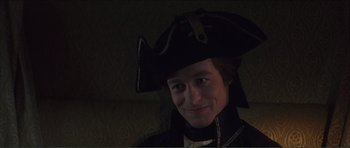 Movie still from “The Affair of the Necklace” (2001), directed by Charles Shyer – A man wearing a pirate's hat smiling for the camera; Close Up shot, High angle