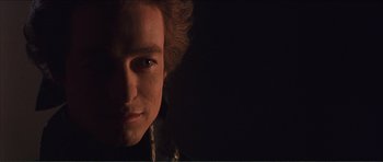 Movie still from “The Affair of the Necklace” (2001), directed by Charles Shyer – A man's face in the dark; Close Up shot, Over the shoulder angle