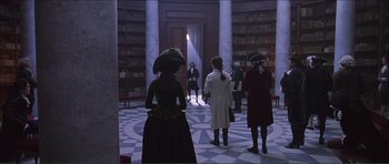Movie still from “The Affair of the Necklace” (2001), directed by Charles Shyer – A group of people standing in front of a library; Wide shot, High angle