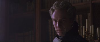 Movie still from “The Affair of the Necklace” (2001), directed by Charles Shyer – A person wearing a suit and tie; Close Up shot, Low angle