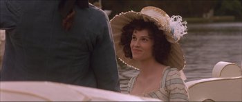 Movie still from “The Affair of the Necklace” (2001), directed by Charles Shyer – A woman in a hat is standing in the water; Close Up shot, Over the shoulder angle