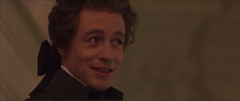 Movie still from “The Affair of the Necklace” (2001), directed by Charles Shyer – A person wearing a suit and bow tie; Close Up shot, Over the shoulder angle