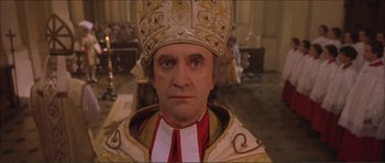 Movie still from “The Affair of the Necklace” (2001), directed by Charles Shyer – A person wearing a priest costume; Close Up shot, Low angle