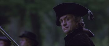 Movie still from “The Affair of the Necklace” (2001), directed by Charles Shyer – A person wearing a hat and looking to his left; Close Up shot, Low angle