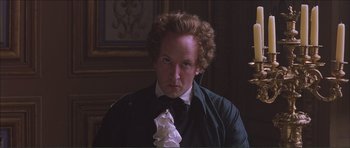 Movie still from “The Affair of the Necklace” (2001), directed by Charles Shyer – A man with curly brown hair wearing a bow tie; Close Up shot, Low angle