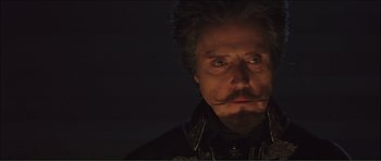 Movie still from “The Affair of the Necklace” (2001), directed by Charles Shyer – A person with a beard and a mustache; Close Up shot, Low angle