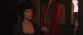 Movie still from “The Affair of the Necklace” (2001), directed by Charles Shyer – A woman standing next to a man in a red jacket; Close Up shot, Over the shoulder angle