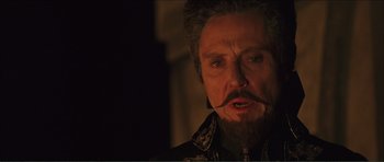 Movie still from “The Affair of the Necklace” (2001), directed by Charles Shyer – A man with a beard and a mustache is looking at the camera; Close Up shot, Low angle