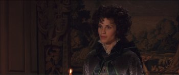 Movie still from “The Affair of the Necklace” (2001), directed by Charles Shyer – A woman standing in front of a lit candle; Close Up shot, Over the shoulder angle