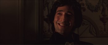 Movie still from “The Affair of the Necklace” (2001), directed by Charles Shyer – A person with a beard smiling; Close Up shot, Low angle