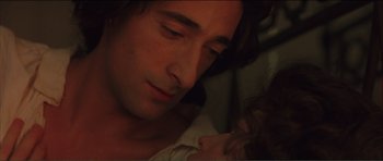 Movie still from “The Affair of the Necklace” (2001), directed by Charles Shyer – A person laying in a bed with a baby; Close Up shot, High angle