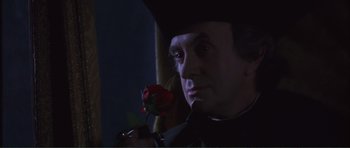 Movie still from “The Affair of the Necklace” (2001), directed by Charles Shyer – A person holding a rose; Close Up shot, Over the shoulder angle