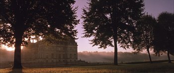 Movie still from “The Affair of the Necklace” (2001), directed by Charles Shyer – A large house in the middle of a field with a tree; Extreme Wide shot, Low angle