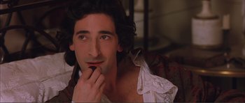 Movie still from “The Affair of the Necklace” (2001), directed by Charles Shyer – A person with a hand on his chin; Close Up shot, High angle