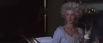 Movie still from “The Affair of the Necklace” (2001), directed by Charles Shyer – A woman in a white dress sitting in front of a map; Close Up shot, Over the shoulder angle
