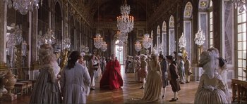Movie still from “The Affair of the Necklace” (2001), directed by Charles Shyer – A group of people standing in a room with chandeliers; Extreme Wide shot, High angle