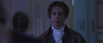 Movie still from “The Affair of the Necklace” (2001), directed by Charles Shyer – A person wearing a suit and tie; Close Up shot, Over the shoulder angle