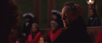 Movie still from “The Affair of the Necklace” (2001), directed by Charles Shyer – A man in black jacket looking to his left; Close Up shot, Over the shoulder angle