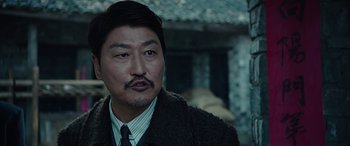 Movie still from “The Age of Shadows” (2016), directed by Jee-woon Kim – A person wearing a suit and tie; Close Up shot, Over the shoulder angle