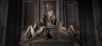 Movie still from “The Agony and the Ecstasy” (1965), directed by Carol Reed – A statue of a man sitting on a pedestal with two naked men; Wide shot, High angle