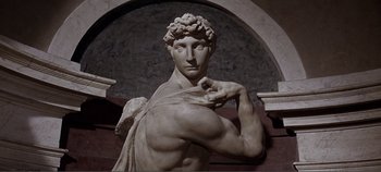 Movie still from “The Agony and the Ecstasy” (1965), directed by Carol Reed – A marble statue of a man with his arms crossed; Medium shot, Low angle