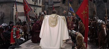 Movie still from “The Agony and the Ecstasy” (1965), directed by Carol Reed – A group of men in medieval garb standing in front of a priest; Wide shot, High angle