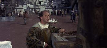 Movie still from “The Agony and the Ecstasy” (1965), directed by Carol Reed – A man in a renaissance costume standing in front of geese; Medium shot, Over the shoulder angle