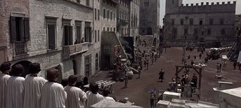 Movie still from “The Agony and the Ecstasy” (1965), directed by Carol Reed – A group of people standing on the side of a street; Extreme Wide shot, High angle