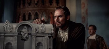 Movie still from “The Agony and the Ecstasy” (1965), directed by Carol Reed – A man in medieval garb looking at a statue; Close Up shot, Low angle
