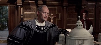 Movie still from “The Agony and the Ecstasy” (1965), directed by Carol Reed – An old man in a robe and a chain around his neck; Medium shot, Low angle