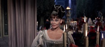 Movie still from “The Agony and the Ecstasy” (1965), directed by Carol Reed – A woman wearing a crown and holding a lit candle; Close Up shot, Over the shoulder angle