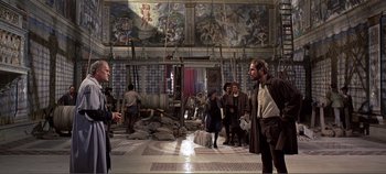 Movie still from “The Agony and the Ecstasy” (1965), directed by Carol Reed – A group of people standing around in a room; Wide shot, Low angle