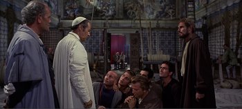 Movie still from “The Agony and the Ecstasy” (1965), directed by Carol Reed – A group of men standing in front of a man in a priest's outfit; Wide shot, Over the shoulder angle