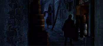 Movie still from “The Agony and the Ecstasy” (1965), directed by Carol Reed – Two people walking down a dark alleyway at night; Wide shot, Over the shoulder angle