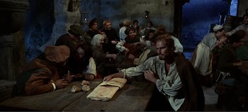 Movie still from “The Agony and the Ecstasy” (1965), directed by Carol Reed – A group of people sitting around a table; Medium shot, High angle