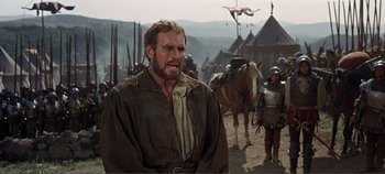 Movie still from “The Agony and the Ecstasy” (1965), directed by Carol Reed – A man with a beard is standing next to a horse; Medium shot, Over the shoulder angle
