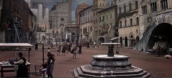 Movie still from “The Agony and the Ecstasy” (1965), directed by Carol Reed – A group of people walking around a fountain in the middle of a city; Extreme Wide shot, High angle