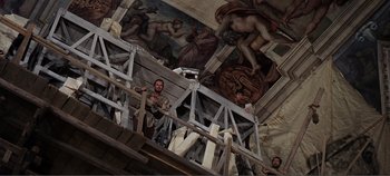 Movie still from “The Agony and the Ecstasy” (1965), directed by Carol Reed – A group of people standing on a platform in front of a mural; Wide shot, Low angle