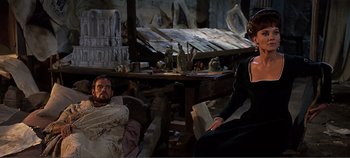 Movie still from “The Agony and the Ecstasy” (1965), directed by Carol Reed – A man and a woman sitting on a chair in a room; Medium shot, High angle