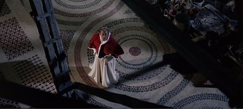 Movie still from “The Agony and the Ecstasy” (1965), directed by Carol Reed – An old man dressed in a red and white outfit; Wide shot, Overhead angle