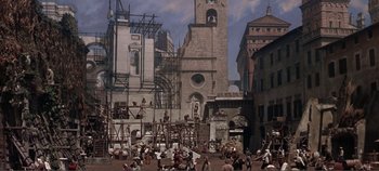 Movie still from “The Agony and the Ecstasy” (1965), directed by Carol Reed – A group of people standing around in front of a building; Extreme Wide shot, High angle