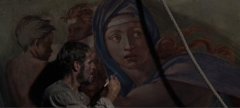 Movie still from “The Agony and the Ecstasy” (1965), directed by Carol Reed – A man is painting a painting of a woman; Close Up shot, Low angle