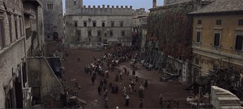 Movie still from “The Agony and the Ecstasy” (1965), directed by Carol Reed – A group of people standing around in a courtyard; Extreme Wide shot, High angle