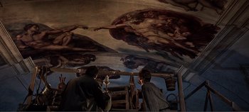 Movie still from “The Agony and the Ecstasy” (1965), directed by Carol Reed – Two men are standing in front of a painting of the sistine chapel; Wide shot, Overhead angle