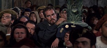 Movie still from “The Agony and the Ecstasy” (1965), directed by Carol Reed – A group of people sitting in a room; Medium shot, Over the shoulder angle