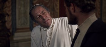 Movie still from “The Agony and the Ecstasy” (1965), directed by Carol Reed – A man wearing a white shirt and a chain around his neck; Close Up shot, Over the shoulder angle